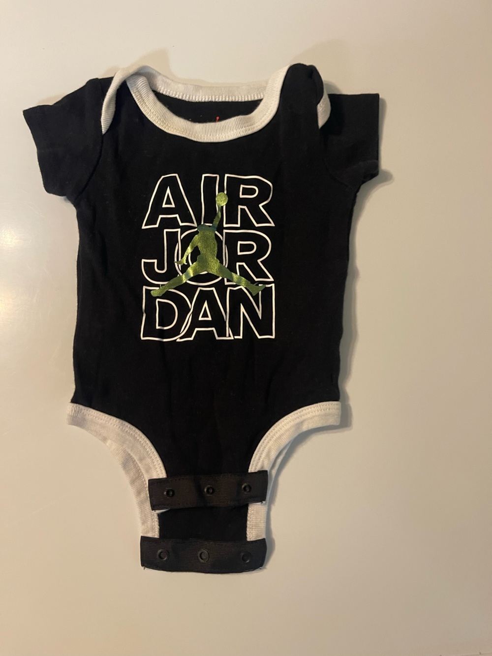 Jordan Infant Black and White onesie with Green Jumpman